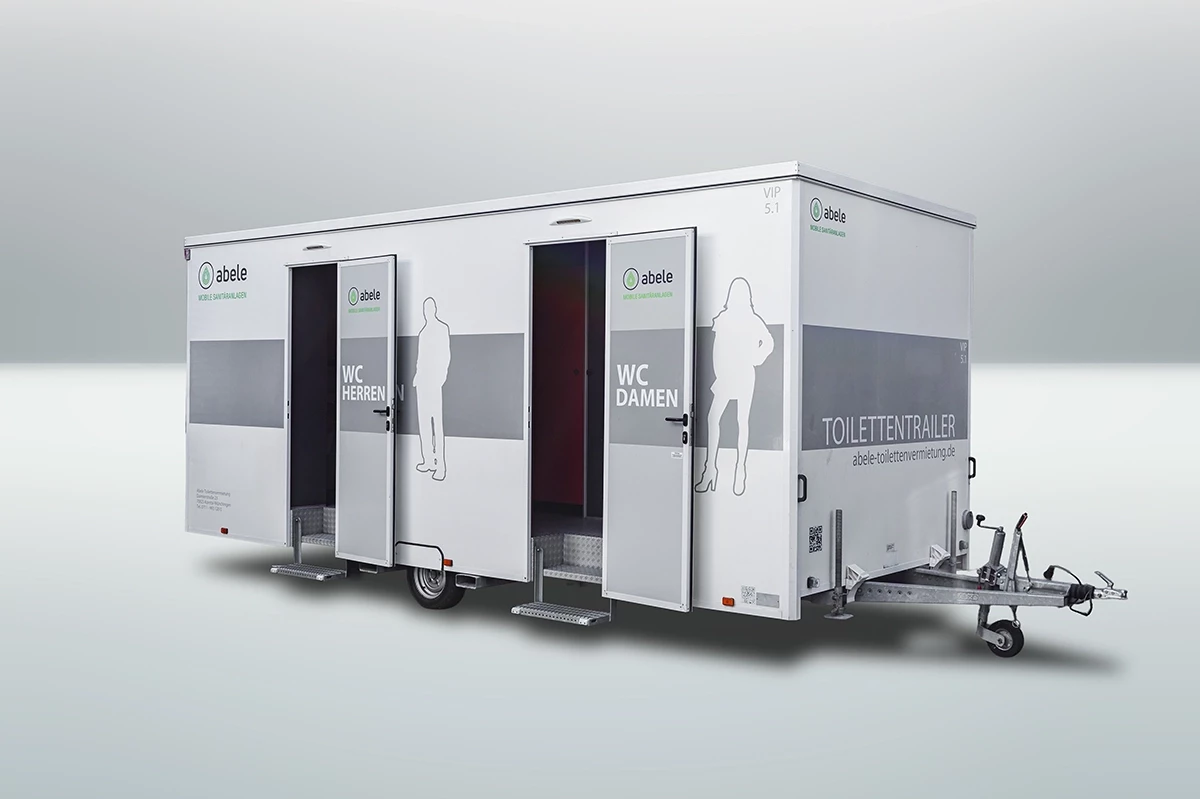 Mobiler Toilettenanhänger mit separaten Eingängen für Herren und Damen, jeweils mit Piktogramm gekennzeichnet.